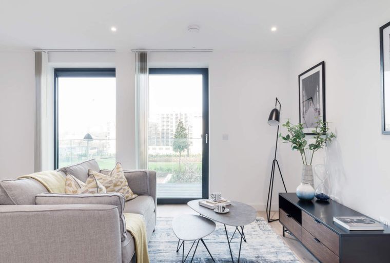 A living room with a sofa, coffee table, and entertainment unit.