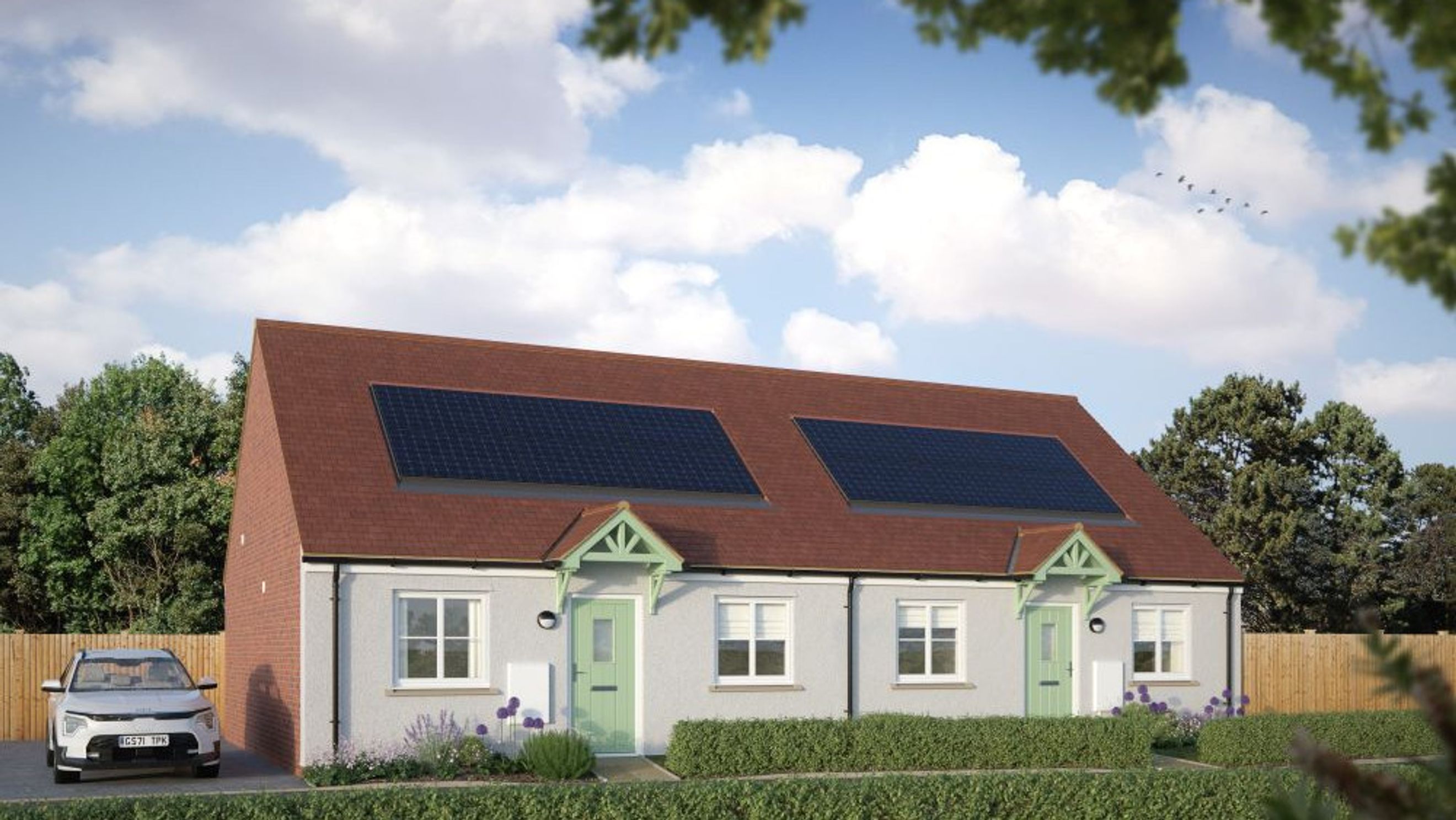 A semi-detached house with solar panels on the roof, a green front door, and a car parked in the driveway.
