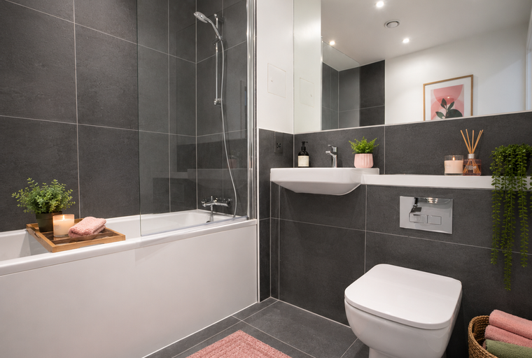 A bathroom with a bathtub, shower, sink, and toilet.