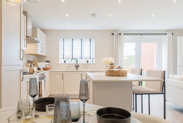 A kitchen and dining area with cabinets, a sink, a window, and a dining table with chairs.