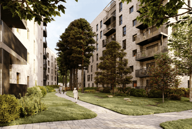 A view of apartment buildings with balconies and trees in a courtyard.