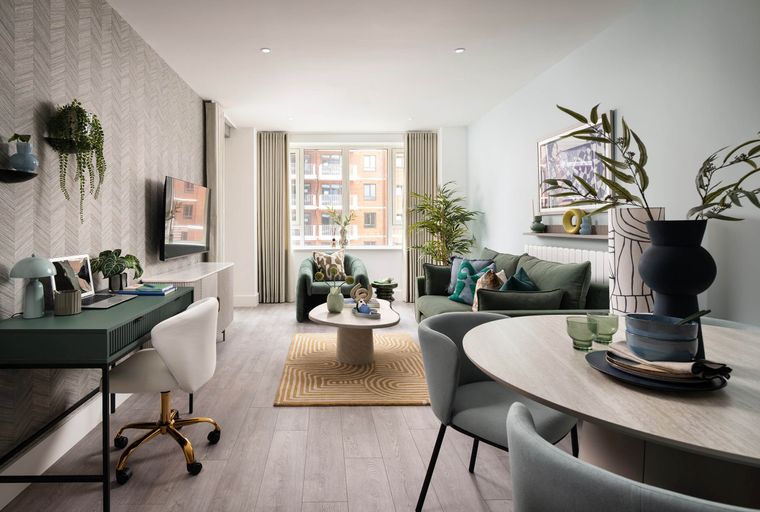 A living and dining area with a desk, sofa, coffee table, and dining table.