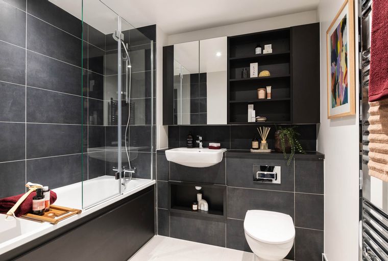 A modern bathroom with a bathtub, sink, and toilet.