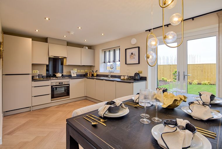 A modern kitchen and dining area with a table set for a meal.