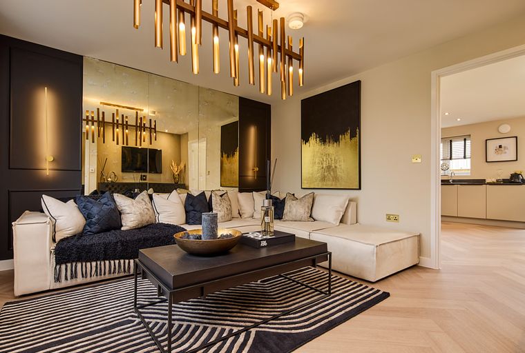 A living room with a sectional sofa, coffee table, and abstract art.