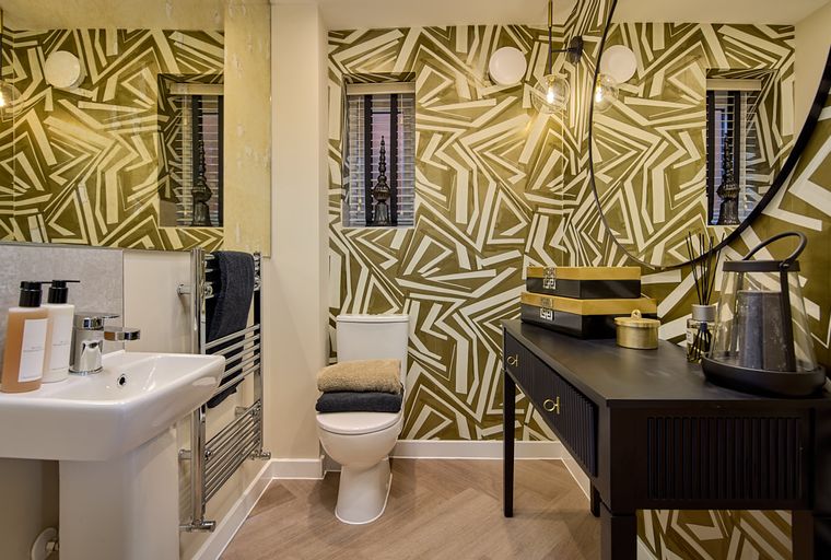 A bathroom with a sink, toilet, and vanity.