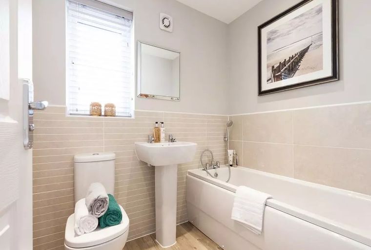 A bathroom with a bathtub, sink, and toilet.