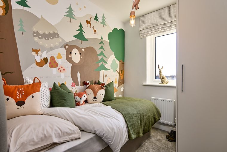 A bedroom with a bed, animal-themed pillows, a window, and a mural.