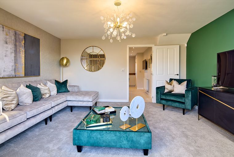 A living room with a sectional sofa, armchair, coffee table, and media console.