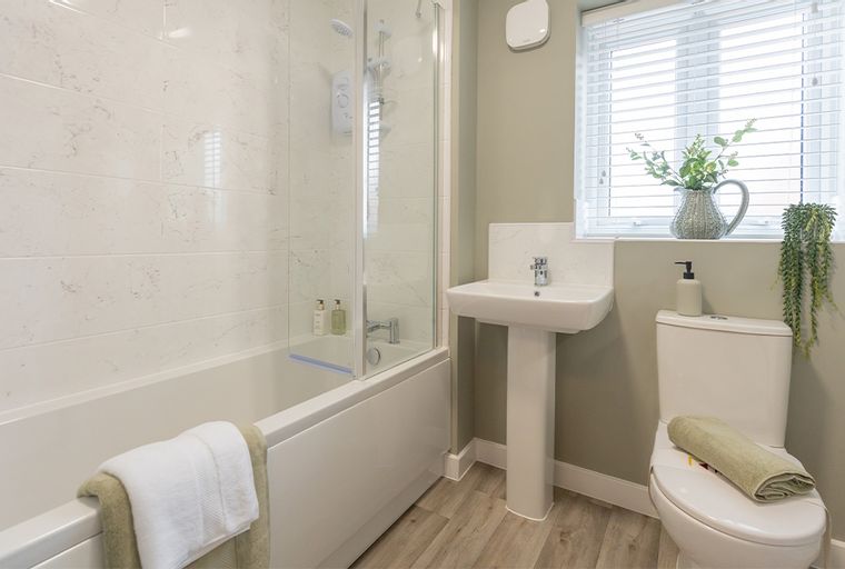 A bathroom with a bathtub, shower, sink, and toilet.