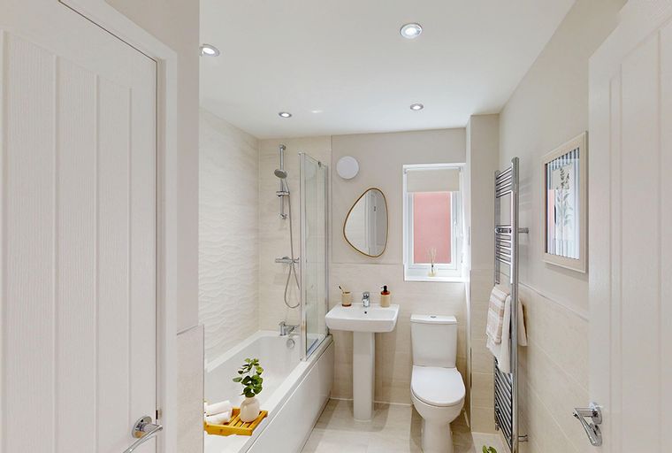 A bathroom with a bathtub, shower, sink, and toilet.