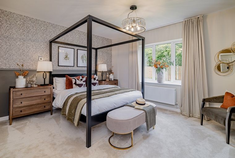 A bedroom with a four-poster bed, dresser, and a bench.