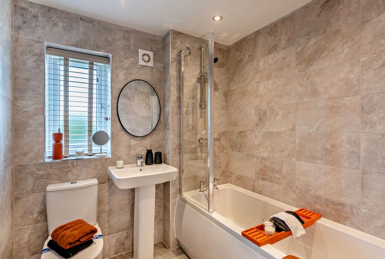 A bathroom with a bathtub, shower, sink, and toilet.