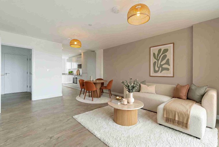 A living room and dining area with a sofa, coffee table, dining table, and chairs.