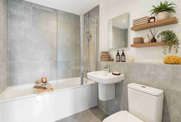 A bathroom with a bathtub, sink, and toilet.