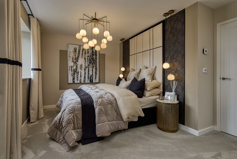 A bedroom with a bed, curtains, and a chandelier.