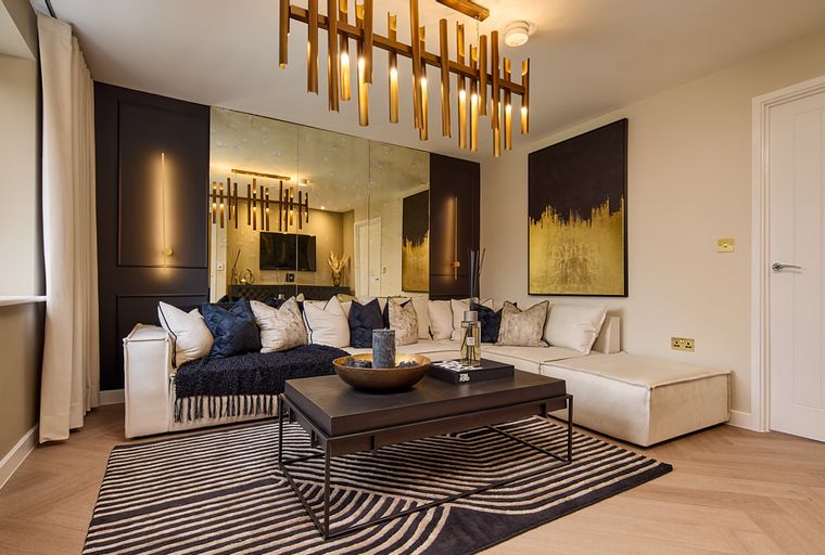A living room with a sectional sofa, coffee table, rug, and artwork.