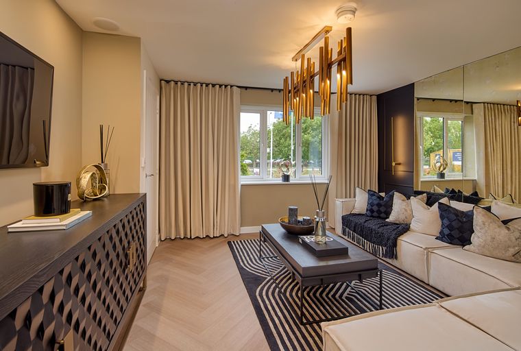 A living room with a media console, sofa, coffee table, and chandelier.