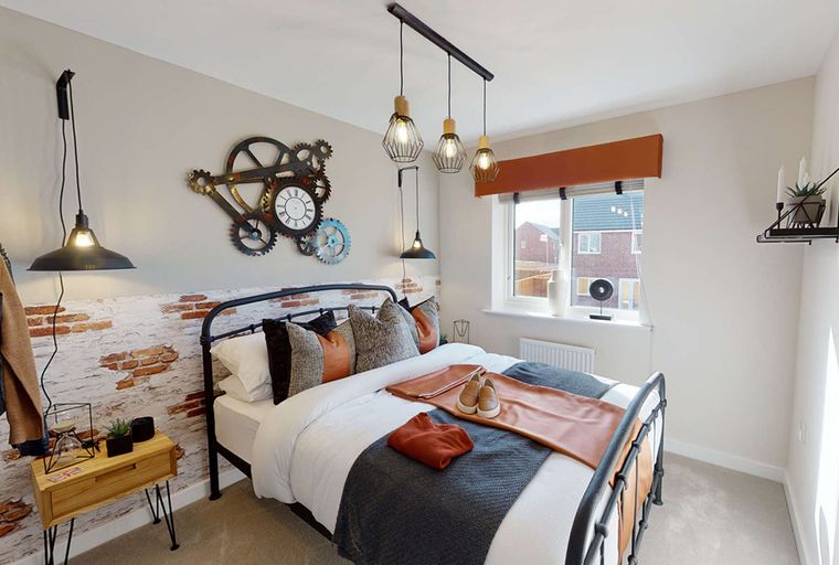 A bedroom with a bed, bedside table, and wall clock.