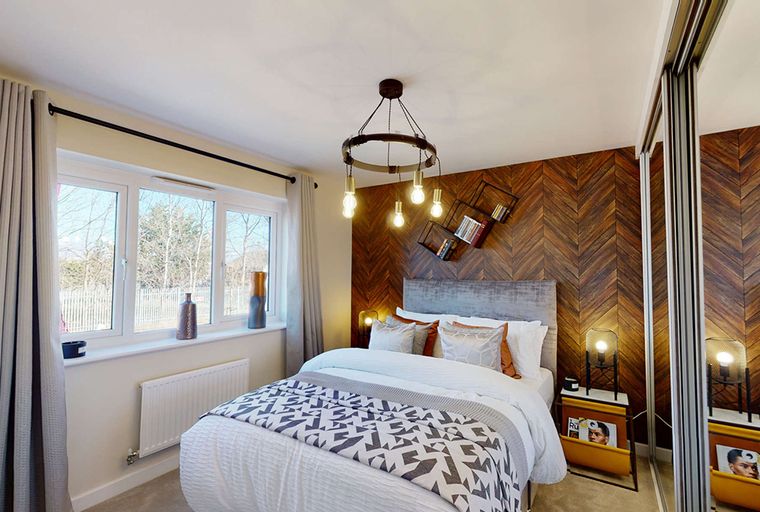 A bedroom with a bed, nightstands, and a window.