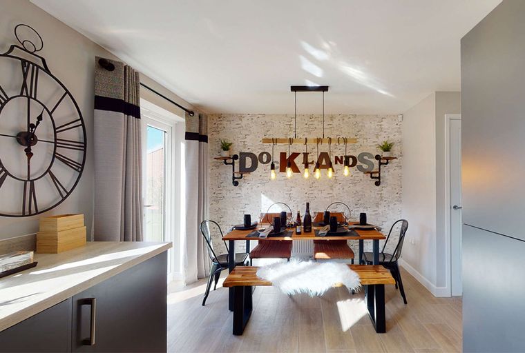 A dining room with a wooden table, benches, and decorative wall art.