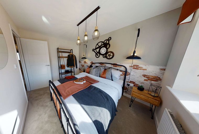 A bedroom with a bed, a clock, and pendant lights.