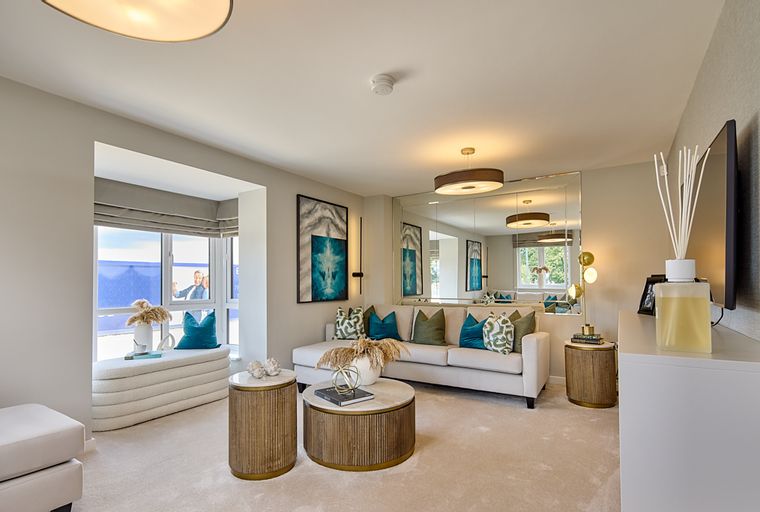 A living room with a sofa, coffee table, and a large window.