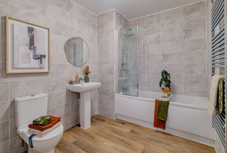 A bathroom with a toilet, sink, bathtub, and shower.