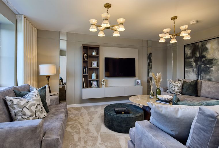 A living room with sofas, a TV, and a coffee table.