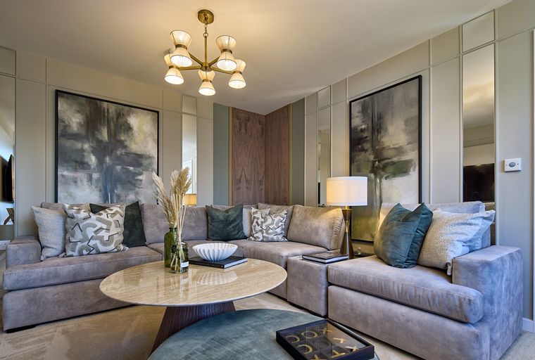 A sectional sofa in a living room with a coffee table and artwork.