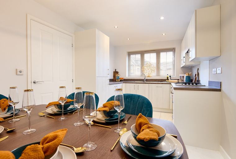 A dining table set for a meal in a kitchen.