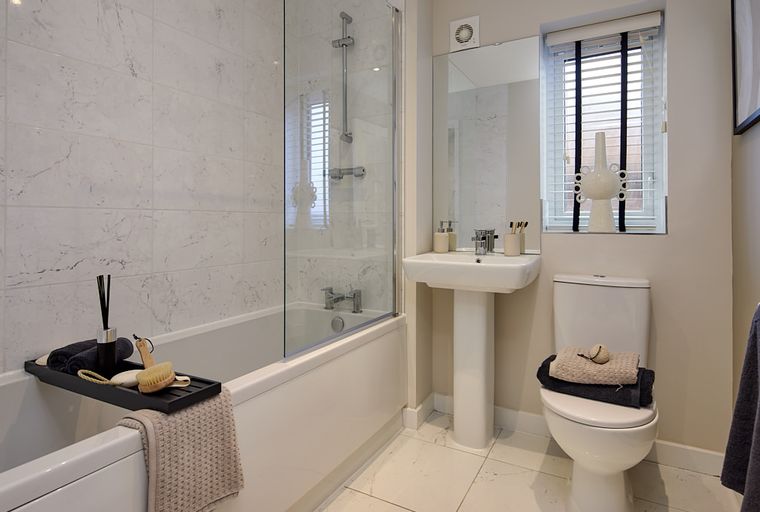 A bathroom with a bathtub, sink, and toilet.
