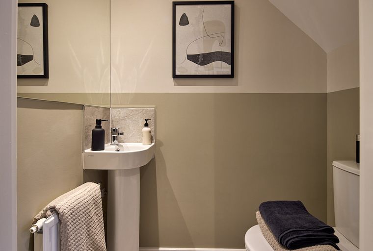A bathroom with a sink, radiator, and toilet.