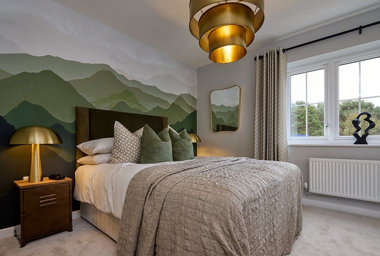 A bedroom with a bed, a mountain mural, and a bedside lamp.