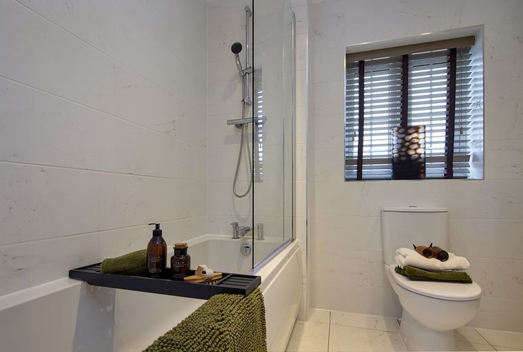 A bathroom with a bathtub, shower, and toilet.