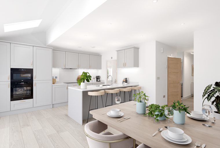 A modern kitchen and dining area with light wood flooring, grey cabinets, and a large island with bar stools.