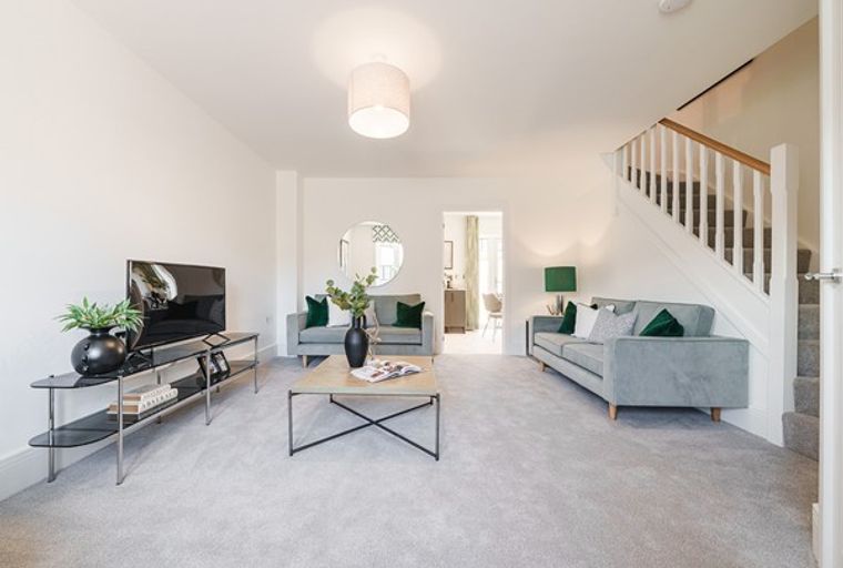 A living room with two sofas, a coffee table, and a television.