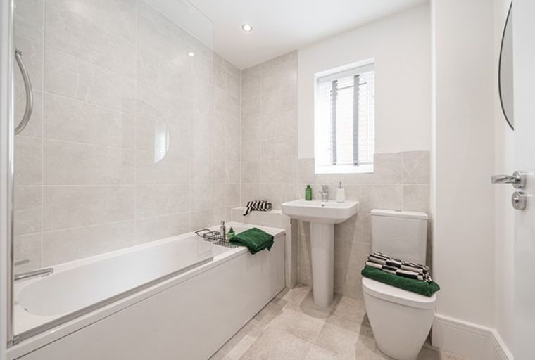 A bathroom with a bathtub, sink, and toilet.