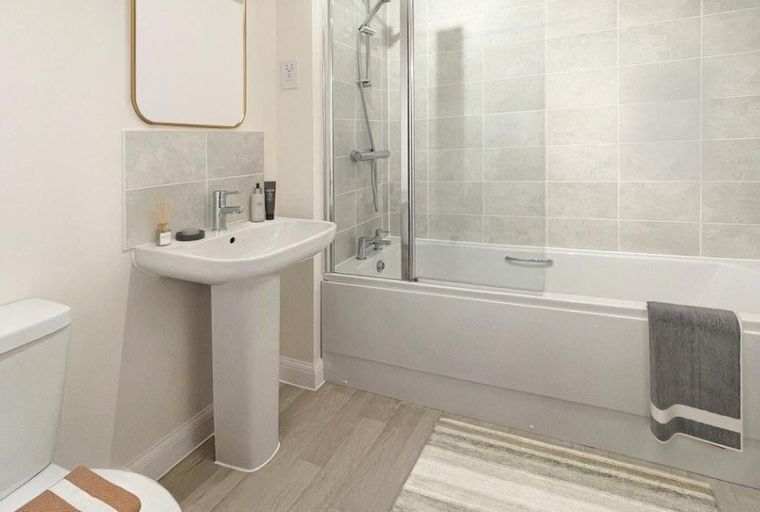 A bathroom with a toilet, sink, and bathtub.