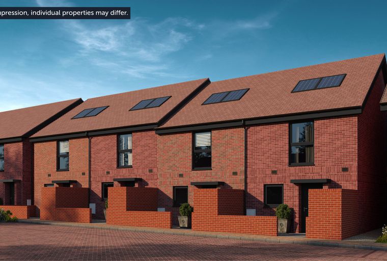 A row of modern red brick townhouses with solar panels on the roof.