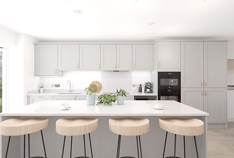 A modern kitchen with light gray cabinets, a large island, and bar stools.