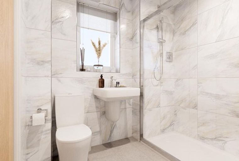 A bathroom with a toilet, sink, and shower.