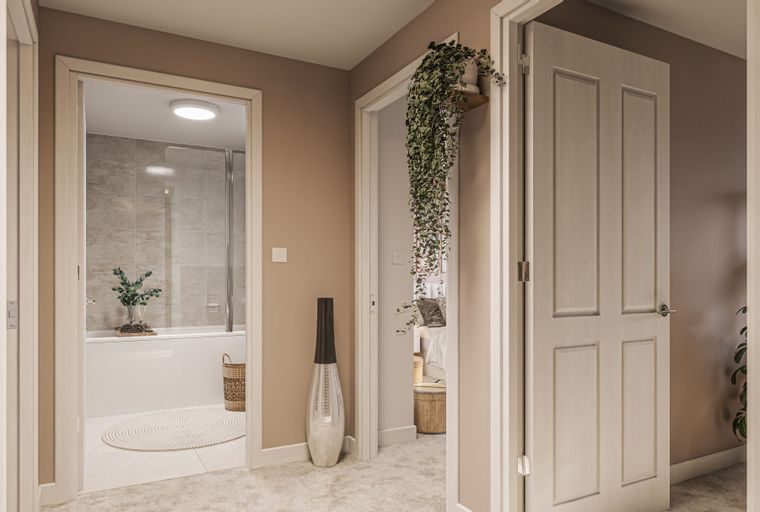 A hallway with two open doors, one leading to a bathroom and the other to a bedroom.