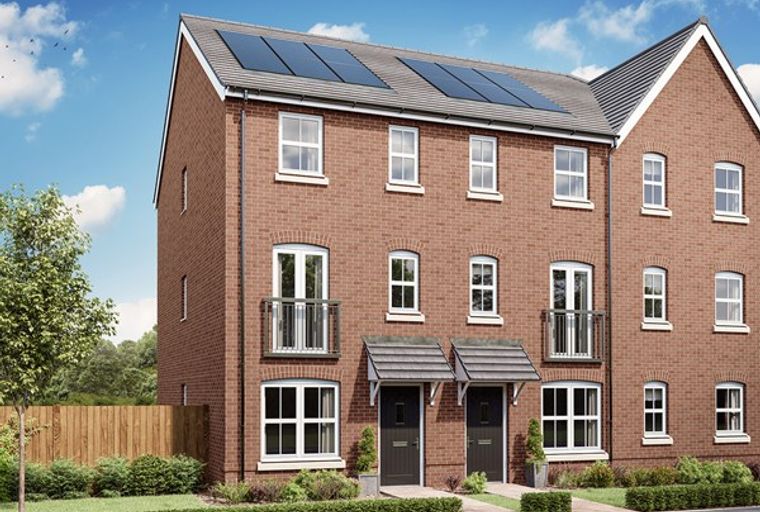 A row of modern red brick townhouses with solar panels on the roof.