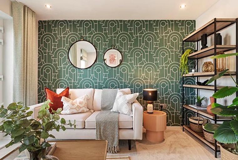 A living room with a sofa, patterned wallpaper, and a shelving unit.