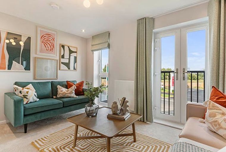 A living room with a teal sofa, coffee table, and artwork.