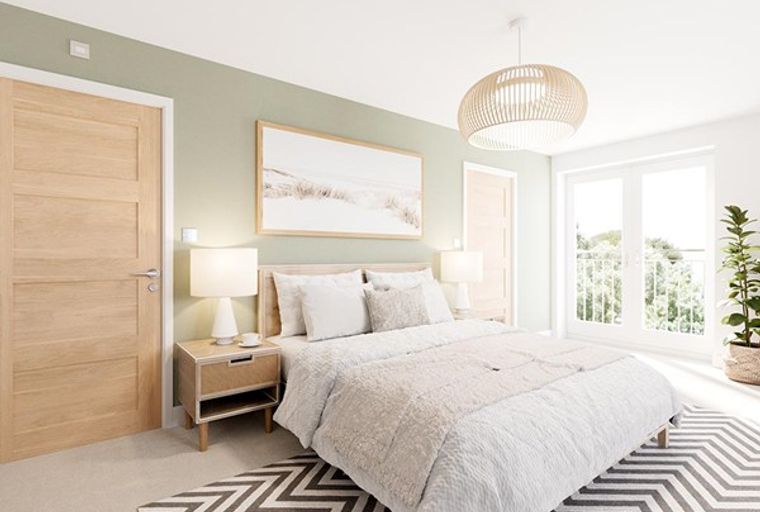 A bedroom with a bed, nightstands, and doors.
