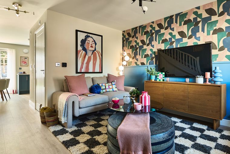 A living room with a sofa, coffee table, and television.