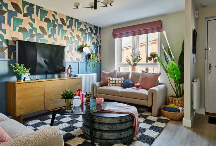 A living room with a sofa, coffee table, and television.