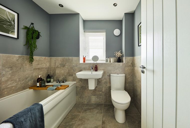A bathroom with a bathtub, sink, and toilet.